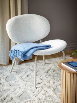 Fauteuil lounge en tissu bouclé